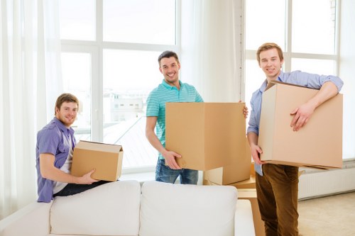 Removal team wearing PPE while moving furniture safely