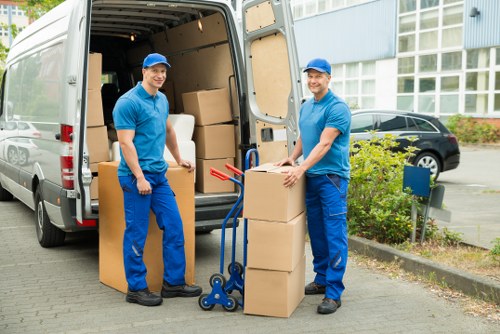 Local moving specialists handling packed boxes with care