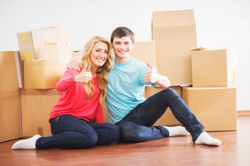 Professional movers carrying furniture from a flat in Streatham