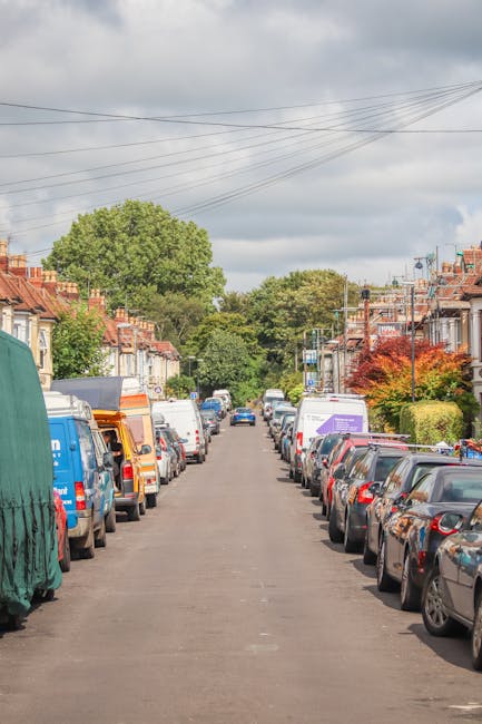 The image shows a busy street scene on Leigham Court Road with a row of multi-storey terraced houses featuring pitched roofs and brick facades. Several shopfronts, including a convenience store with a